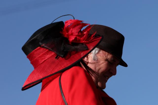 Racegoers arrive on the fourth day of the Cheltenham Festival at Cheltenham Racecourse, in Cheltenham, western England on March 13, 2026. (Photo by Adrian Dennis / AFP)
