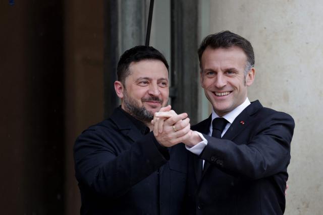 France's President Emmanuel Macron (R) welcomes Ukraine's President Volodymyr Zelensky before a meeting at The Elysee Presidential Palace in Paris on March 13, 2026. (Photo by Ludovic MARIN / AFP)