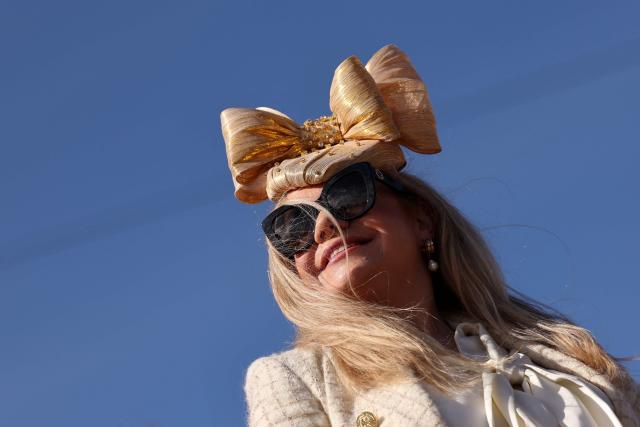 Racegoers arrive on the fourth day of the Cheltenham Festival at Cheltenham Racecourse, in Cheltenham, western England on March 13, 2026. (Photo by Adrian Dennis / AFP)