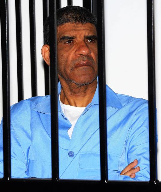 (FILES) Former Libyan intelligence chief Abdullah al-Senussi, dressed in prison blues, sits behind the accused cell during a hearing as part of his trial in a courthouse in Tripoli on June 22, 2014. Thirty-seven former Kadhafi regime officials are charged with murder, kidnapping, complicity in incitement to rape, plunder, sabotage, embezzlement of public funds and acts harmful to national unity. AFP PHOTO / MAHMUD TURKIA. In September 2025, the Paris criminal court handed down a heavy sentence against Nicolas Sarkozy, punishing "corruption at the highest level" of "exceptional gravity" in order "to obtain Libyas commitment to provide financial support" for his 2007 presidential campaign. Nicolas Sarkozy, who has always disputed this account, will now have to challenge on appeal the findings of the trial judges, who identified him as both an actor in and a beneficiary of a criminal conspiracy starting on March 16, 2026. (Photo by Mahmud TURKIA / AFP)
