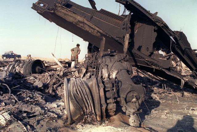 (FILES) A soldier looks at the wreckage of the UTA DC-10 flight 772 in the Tenere desert, on September 21, 1989 after the passenger plane exploded overhere on September 19, 1989 killing all 171 people aboard, because of a bomb in the luggage tank of the plane. In September 2025, the Paris criminal court handed down a heavy sentence against Nicolas Sarkozy, punishing "corruption at the highest level" of "exceptional gravity" in order "to obtain Libyas commitment to provide financial support" for his 2007 presidential campaign. Nicolas Sarkozy, who has always disputed this account, will now have to challenge on appeal the findings of the trial judges, who identified him as both an actor in and a beneficiary of a criminal conspiracy starting on March 16, 2026. (Photo by Christian SPILLMANN / AFP)