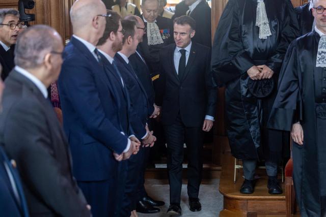 France's President Emmanuel Macron (C) attends the investiture ceremony of newly appointed French Court of Auditors president Amelie de Montchalin (unseen) at the Court of Auditors headquarters in Paris, on March 13, 2026. (Photo by Christophe PETIT TESSON / POOL / AFP)