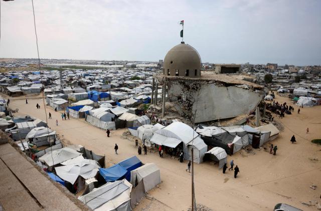 Palestinian Muslims pray during the last Friday noon prayer of the Muslim holy fasting month of Ramadan, outside the Al-Talbani Mosque, destroyed by the Israeli military in Khan Yunis, in the southern Gaza Strip on  March 13, 2026. (Photo by Bashar Taleb / AFP)