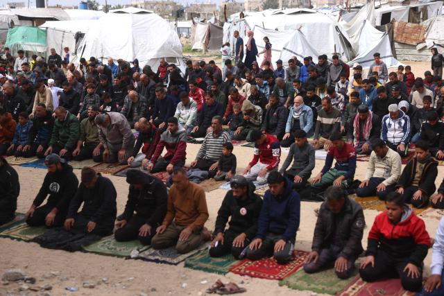 Palestinians pray during the last Friday noon prayer of the Muslim holy fasting month of Ramadan, at the Al-Talbani Mosque, destroyed by the Israeli military in Khan Yunis, in the southern Gaza Strip on March 13, 2026. (Photo by Bashar Taleb / AFP)