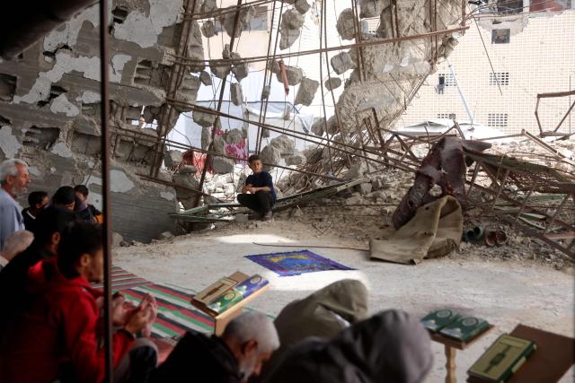 Palestinians pray during the last Friday noon prayer of the Muslim holy fasting month of Ramadan, at the Al-Talbani Mosque, destroyed by the Israeli military in Khan Yunis, in the southern Gaza Strip on March 13, 2026. (Photo by Bashar Taleb / AFP)
