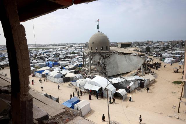 Palestinian Muslims pray during the last Friday noon prayer of the Muslim holy fasting month of Ramadan, outside the Al-Talbani Mosque, destroyed by the Israeli military in Khan Yunis, in the southern Gaza Strip on  March 13, 2026. (Photo by Bashar Taleb / AFP)