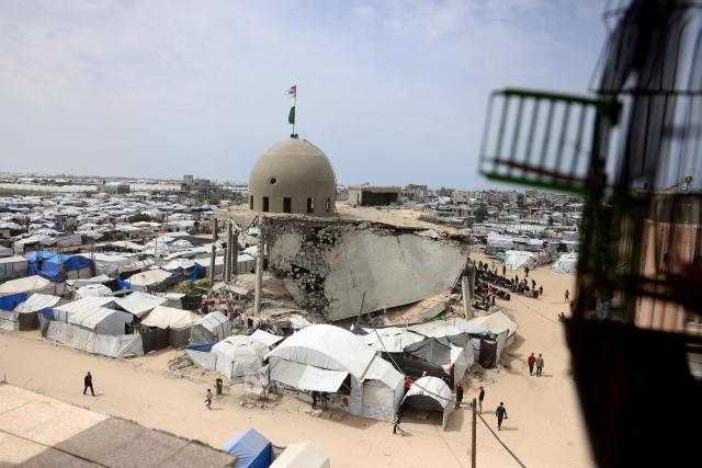 Palestinian Muslims pray during the last Friday noon prayer of the Muslim holy fasting month of Ramadan, outside the Al-Talbani Mosque, destroyed by the Israeli military in Khan Yunis, in the southern Gaza Strip on  March 13, 2026. (Photo by Bashar Taleb / AFP)