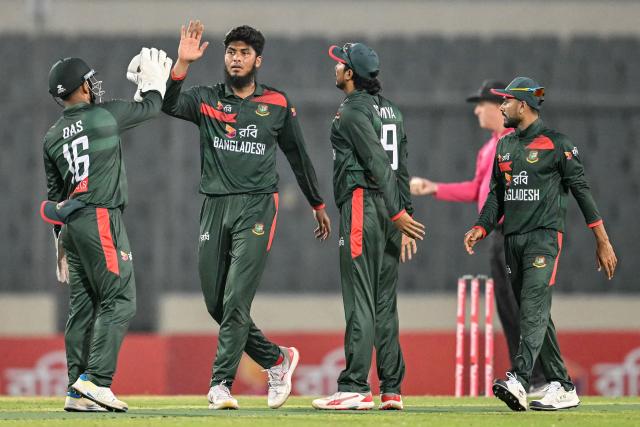 Bangladesh's Rishad Hossain (2L) celebrates with teammates after taking the wicket of Pakistan's Mohammad Wasim during the second one-day international (ODI) cricket match between Bangladesh and Pakistan at Sher-e-Bangla National Stadium in Mirpur on March 13, 2026. (Photo by Munir UZ ZAMAN / AFP)