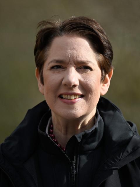 Silke Gorissen, North Rhine-Westphalia's minister for Agriculture and Consumer Protection, smiles after planting a wild pear tree on a newly cleared plot at the Centre for Forestry and Timber Industry in Arnsberg, western Germany on March 13, 2026. The Centre, which includes also Forest Genetics and Propagation Division, manages the new seed orchard, where genetic resources are preserved and make an important contribution to the climate-adapted development of forests in North Rhine-Westphalia. Over the past three years, around 15 tonnes of raw seed have been harvested from the 74 plantations, from both tree species requiring special protection and those that are already key components of North Rhine-Westphalias forests. (Photo by Ina FASSBENDER / AFP)