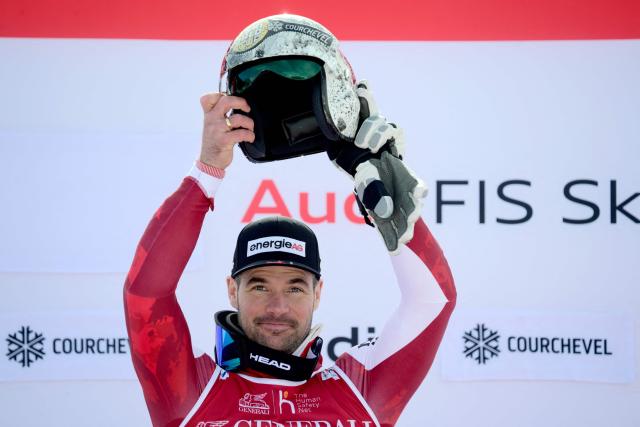 Austria's Vincent Kriechmayr celebrates on the podium after winning the Men's Downhill event of the FIS Alpine World Cup in Courchevel, French Alps, on March 13, 2026. (Photo by Olivier CHASSIGNOLE / AFP)