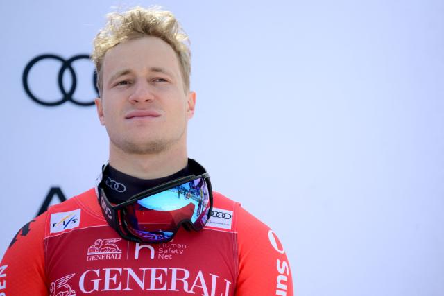 Third placed Switzerland's Marco Odermatt stands on the podium after the Men's Downhill event of the FIS Alpine World Cup in Courchevel, French Alps, on March 13, 2026. (Photo by Olivier CHASSIGNOLE / AFP)