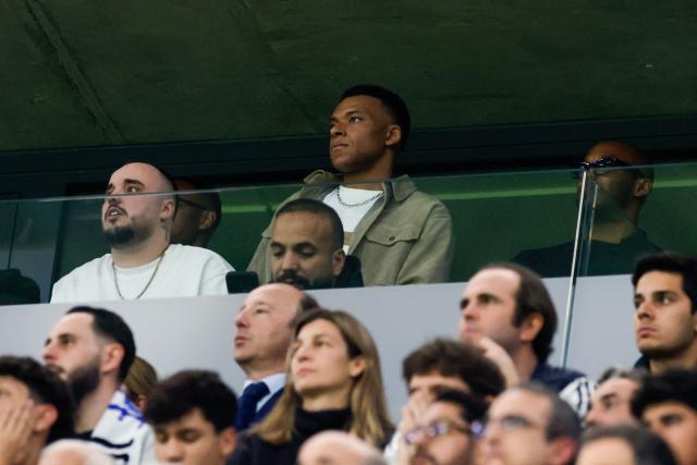 (FILES) Real Madrid's French forward #10 Kylian Mbappe (C) watches the match during the UEFA Champions League last 16 first leg football match between Real Madrid CF and Manchester City at Santiago Bernabeu Stadium in Madrid on March 11, 2026. Real Madrid coach Alvaro Arbeloa said on March 13, 2026 he was "confident" that Kylian Mbappe will be available to face Manchester City in the second leg of their Champions League last 16 tie. (Photo by Oscar DEL POZO / AFP)