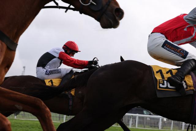 Jockey Patrick Mullins rides racehorse Apolon De Charnie (C) to win the JCB Triumph Hurdle horse race on the fourth day of the Cheltenham Festival at Cheltenham Racecourse, in Cheltenham, western England on March 13, 2026. (Photo by Adrian Dennis / AFP)