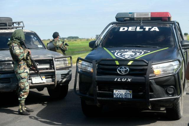 Police officers stand guard at the Viru Viru airport in Santa Cruz, Bolivia, where Uruguayan alleged drug trafficker Sebastian Marset is reportedly being transferred after an operation carried out by agents from the Special Counter-Narcotics Force and the Tactical Police Operations Unit (UTOP), on March 13, 2026. A top Latin American narco trafficker, Sebastian Enrique Marset Cabrera, who was wanted in several countries, including the United States, was arrested Friday in Bolivia, a government source told AFP. (Photo by Rodrigo URZAGASTI / AFP)