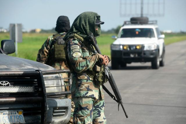 Police officers stand guard at the Viru Viru airport in Santa Cruz, Bolivia, where Uruguayan alleged drug trafficker Sebastian Marset is reportedly being transferred after an operation carried out by agents from the Special Counter-Narcotics Force and the Tactical Police Operations Unit (UTOP), on March 13, 2026. A top Latin American narco trafficker, Sebastian Enrique Marset Cabrera, who was wanted in several countries, including the United States, was arrested Friday in Bolivia, a government source told AFP. (Photo by Rodrigo URZAGASTI / AFP)