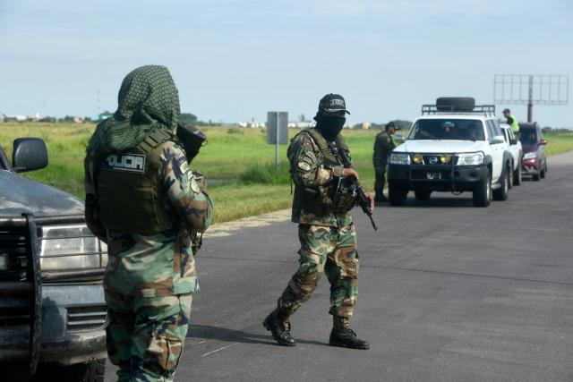 Police officers stand guard at the Viru Viru airport in Santa Cruz, Bolivia, where Uruguayan alleged drug trafficker Sebastian Marset is reportedly being transferred after an operation carried out by agents from the Special Counter-Narcotics Force and the Tactical Police Operations Unit (UTOP), on March 13, 2026. A top Latin American narco trafficker, Sebastian Enrique Marset Cabrera, who was wanted in several countries, including the United States, was arrested Friday in Bolivia, a government source told AFP. (Photo by Rodrigo URZAGASTI / AFP)