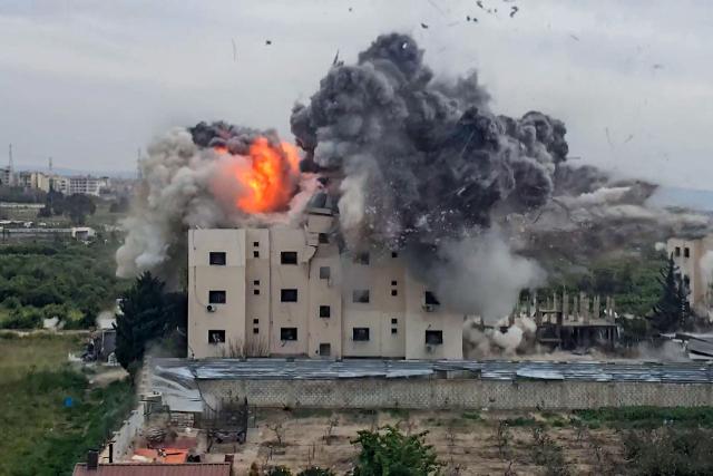 TOPSHOT - A fireball errupts from the site of an Israeli airstrike that targeted a building in the southern Lebanese village of Abbasiyyeh on March 13, 2026. UN Secretary General Antonio Guterres called on Israel and Hezbollah to "stop the war" at the start of a visit to Beirut, saying it was "no longer the time of armed groups". The UN will launch an urgent humanitarian fundraiser on March 13, to assist the more than 800,000 people registered as displaced in Lebanon. (Photo by KAWNAT HAJU / AFP) / 