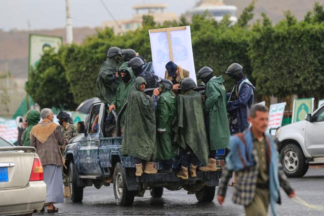 Security forces stand on a pick-up truck as supporters of Yemen's Houthi rebels take part in the Al-Quds (Jerusalem) Day rally, a commemoration in support of the Palestinian people on the last Friday of the Islamic holy month of Ramadan, in Sanaa on March 13, 2026. Yemen's Houthi rebels on March 9, welcomed Iran's ruling clerics appointing their slain leader's son as the country's new supreme leader, calling it a major blow for the Islamic republic's enemies as it fights a war with the United States and Israel. (Photo by Mohammed HUWAIS / AFP)