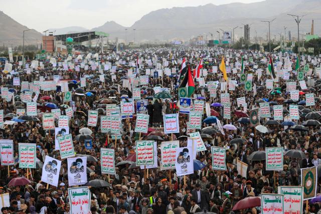 Supporters of Yemen's Houthi rebels hold placards bearing portraits of Irans slain supreme leader Ayatollah Ali Khamenei during the Al-Quds (Jerusalem) Day rally, a commemoration in support of the Palestinian people on the last Friday of the Islamic holy month of Ramadan, in Sanaa on March 13, 2026. Yemen's Houthi rebels on March 9, welcomed Iran's ruling clerics appointing their slain leader's son as the country's new supreme leader, calling it a major blow for the Islamic republic's enemies as it fights a war with the United States and Israel. (Photo by Mohammed HUWAIS / AFP)