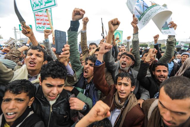 Supporters of Yemen's Houthi rebels raise their fists as they take part in the Al-Quds (Jerusalem) Day rally, a commemoration in support of the Palestinian people on the last Friday of the Islamic holy month of Ramadan, in Sanaa on March 13, 2026. Yemen's Houthi rebels on March 9, welcomed Iran's ruling clerics appointing their slain leader's son as the country's new supreme leader, calling it a major blow for the Islamic republic's enemies as it fights a war with the United States and Israel. (Photo by Mohammed HUWAIS / AFP)