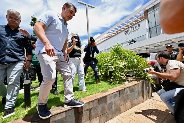 Brazilian Senator Flavio Bolsonaro (2-L), son of former President (2019–2022) Jair Bolsonaro, leaves the DF Star Hospital after visiting his father in Brasilia on March 13, 2026. Former Brazilian president Jair Bolsonaro was taken to hospital onn March 13, 2026 after feeling unwell at the prison where he is serving a sentence for plotting a coup, his son said. (Photo by Evaristo Sa / AFP)