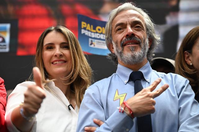 Colombia's presidential candidate for the conservative Democratic Centre party, Paloma Valencia (R), gives the thumb up as her running mate, Juan Daniel Oviedo (R) flashes the V sign, during an event after registering their candidacy, in Bogota, on March 12, 2026. Colombia will hold presidential elections on May 31, 2026. (Photo by RAUL ARBOLEDA / AFP)