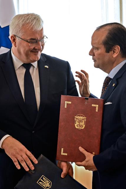 Ukraine’s Minister of Foreign Affairs, Andrii Sybiha (L), and Panama’s Foreign Minister, Javier Martinez-Acha, exchange documents at the Ministry of Foreign Affairs in Panama City on March 13, 2026. During the meeting, the two ministers signed several cooperation agreements. (Photo by MARTIN BERNETTI / AFP)