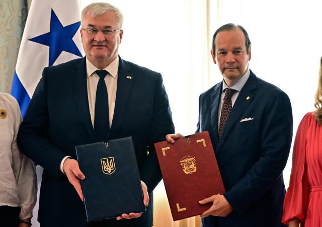 Ukraine’s Minister of Foreign Affairs, Andrii Sybiha (L), and Panama’s Foreign Minister, Javier Martinez-Acha, pose after signing agreements at the Ministry of Foreign Affairs in Panama City on March 13, 2026. (Photo by MARTIN BERNETTI / AFP)