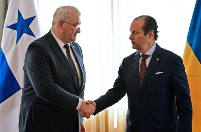 Ukraine’s Minister of Foreign Affairs, Andrii Sybiha (L), shakes hands with Panama’s Foreign Minister, Javier Martinez-Acha, after a press conference at the Ministry of Foreign Affairs in Panama City on March 13, 2026. During the meeting, the two ministers signed several cooperation agreements. (Photo by MARTIN BERNETTI / AFP)