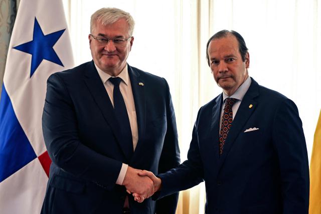 Ukraine’s Minister of Foreign Affairs, Andrii Sybiha (L), shakes hands with Panama’s Foreign Minister, Javier Martinez-Acha, after a press conference at the Ministry of Foreign Affairs in Panama City on March 13, 2026. During the meeting, the two ministers signed several cooperation agreements. (Photo by MARTIN BERNETTI / AFP)