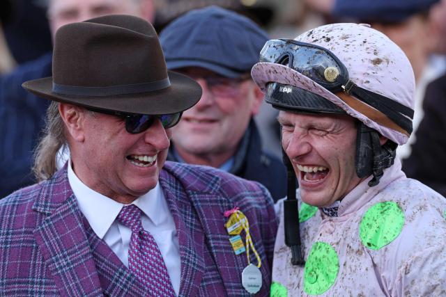 Gaelic Warrior owner Rich Ricci (L) celebrates with jockey Paul Townend after they won the Gold Cup chase horse race on the fourth day of the Cheltenham Festival at Cheltenham Racecourse, in Cheltenham, western England on March 13, 2026. (Photo by Adrian Dennis / AFP)