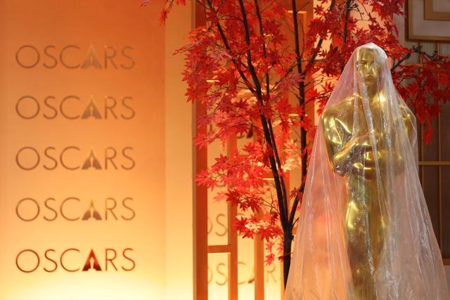 A decorative replica Oscar statue covered in protective plastic sheeting is seen as preparations are made on the red carpet arrivals area ahead of the 98th Annual Academy Awards in Hollywood, California, on March 13, 2026. (Photo by ANGELA WEISS / AFP)