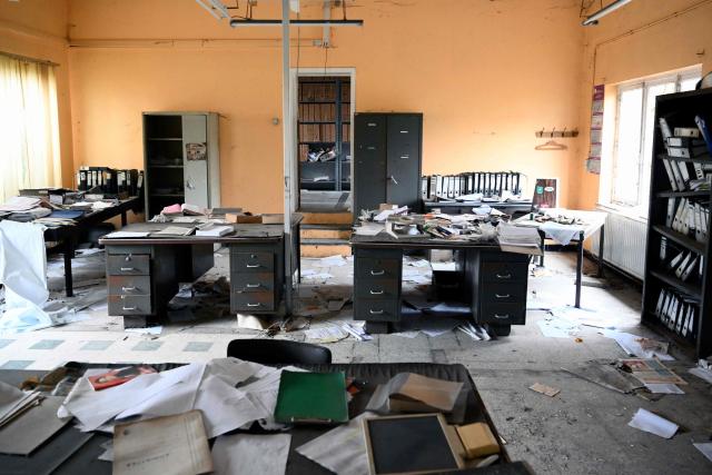 This photograph shows the offices of an abandonned steel plant in Charleroi, southern Belgium, on February 9, 2026. Once a major industrial city of the coal industry, Charleroi still bears the marks of a working-class past now lying fallow. As they venture through its abandoned factories, urban explorers (urbex) end up telling the story of a system as much as of a pastime: that of a capitalism which pours investment into a place, exploits it, then withdraws, leaving behind nothing but ruins to explore. (Photo by Nicolas TUCAT / AFP)