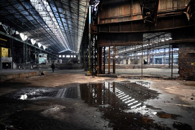 This photograph shows an inside view of an abandoned steel plant in Charleroi, southern Belgium, on February 9, 2026. Once a major industrial city of the coal industry, Charleroi still bears the marks of a working-class past now lying fallow. As they venture through its abandoned factories, urban explorers (urbex) end up telling the story of a system as much as of a pastime: that of a capitalism which pours investment into a place, exploits it, then withdraws, leaving behind nothing but ruins to explore. (Photo by Nicolas TUCAT / AFP)