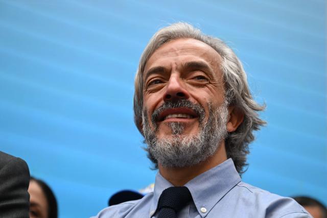 Colombia's vice-presidential candidate for the conservative Democratic Centre party, Juan Daniel Oviedo smiles during a rally after registering his candidacy, in Bogota, on March 12, 2026. Colombia will hold presidential elections on May 31, 2026. (Photo by RAUL ARBOLEDA / AFP)