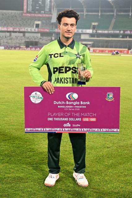 Pakistan’s Maaz Sadaqat poses with the man of the match trophy following the second one-day international (ODI) cricket match between Bangladesh and Pakistan at Sher-e-Bangla National Stadium in Mirpur on March 13, 2026. (Photo by MUNIR UZ ZAMAN / AFP)