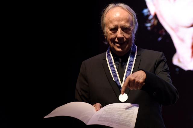 Spanish singer-songwriter Joan Manuel Serrat receives an honorary doctorate from the National University of Cuyo during a ceremony at the Nave UNCuyo complex in Mendoza, Argentina, on March 13, 2026. (Photo by Andres Larrovere / AFP)