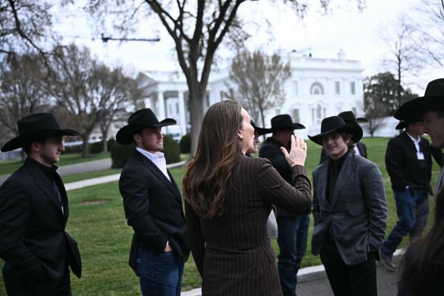 US Secretary of Agriculture Brooke Rollins joined by the National Finals Rodeo champions, walk outside of the West Wing of the White house on March 13, 2026 in Washington, DC. (Photo by Brendan SMIALOWSKI / AFP)