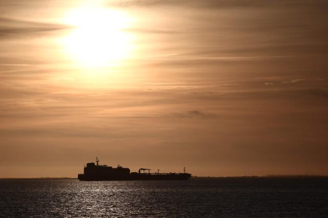 This photograph shows an oil tanker anchored at the Grand Port Maritime de Marseille-Fos at sunset, in Fos-sur-Mer, off the Mediterranean coast of southern France on March 13, 2026. (Photo by Thibaud MORITZ / AFP)