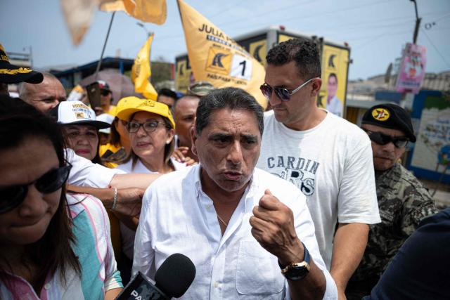 Peru's presidential candidate Carlos Alvarez, for the Pais Para Todos party, speaks to a reporter during a visit to a market in the Ventanilla district on the southern outskirts of Lima on March 13, 2026. (Photo by ERNESTO BENAVIDES / AFP)