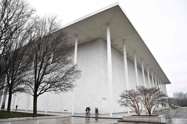 (FILES) People walk in front of the Kennedy Center in Washington, DC on January 10, 2026. US President Donald Trump announced on March 13, 2026 the replacement of the head of the Kennedy Center, the storied Washington arts venue he renamed after himself then closed for two years for refurbishment. Richard Grenell, whom Trump appointed last year to rid the center of what the Republican called "woke" ideology, will be replaced by Matt Floca, the president said on his Truth Social platform. (Photo by Mandel NGAN / AFP)