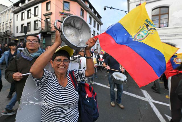 A demonstrator hits a pot during a march against the government called by unions in Quito on March 13, 2026. (Photo by Rodrigo BUENDIA / AFP)