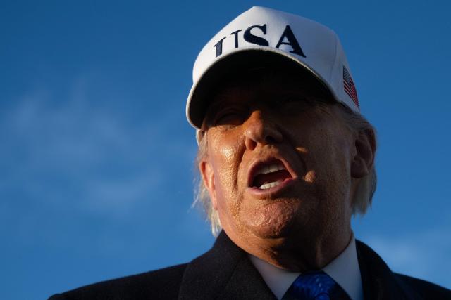 US President Donald Trump speaks to reporters before boarding Air Force One as he departs Joint Base Andrews in Maryland on March 13, 2026. President Trump is heading to Florida to spend the weekend at his Mar-a-Lago resort. (Photo by SAUL LOEB / AFP)