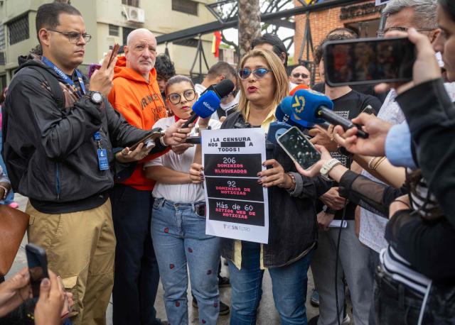Venezuelan National Journalists Association spokesperson Delvalle Canelon speaks to the media during a demonstration to demand unblocking restricted websites in front of the National Commission of Telecommunications (Conatel) headquarters in Caracas on March 13, 2026. Chanting "freedom of expression for the internet and television," human rights activists called on Venezuela's interim government to unblock some 200 restricted websites on March 13, 2026. (Photo by Maryorin Mendez / AFP)