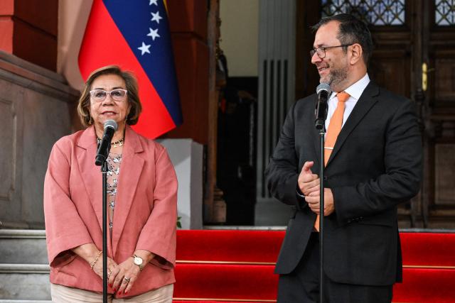 Colombia's Foreign Minister Rosa Yolanda Villavicencio (L) speaks next to Venezuela's Foreign Minister Yvan Gil (R) during press conference following a meeting with interim President Delcy Rodriguez at the Miraflores Presidential Palace in Caracas on March 13, 2026. Venezuela met with a Colombian high-level delegation on March 13, 2026, after the Venezuelan government announced the previous day that a meeting between the presidents of both countries, which was to take place at a border bridge, had been canceled. (Photo by Juan BARRETO / AFP)