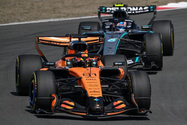 McLaren's Australian driver Oscar Piastri drives in front of Mercedes' Italian driver Kimi Antonelli (back) during the sprint race ahead of the Formula One Chinese Grand Prix at the Shanghai International Circuit in Shanghai on March 14, 2026. (Photo by JADE GAO / AFP)