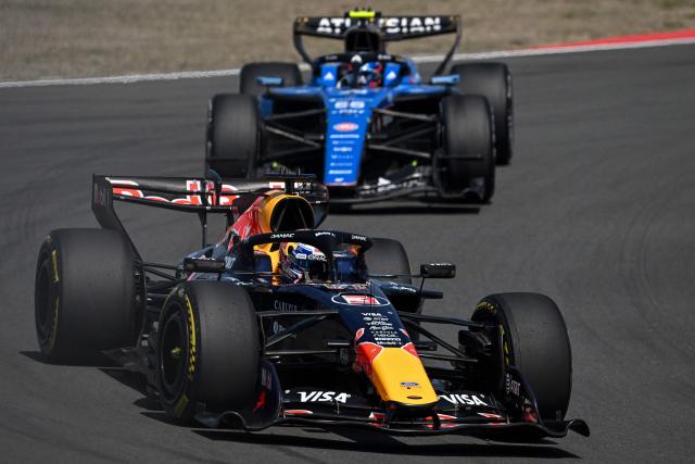 Red Bull Racing's Dutch driver Max Verstappen drives in front of Williams' Spanish driver Carlos Sainz during the sprint race ahead of the Formula One Chinese Grand Prix at the Shanghai International Circuit in Shanghai on March 14, 2026. (Photo by JADE GAO / AFP)