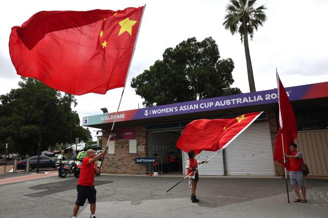 China fans wave the Chinese national flag before the AFC Women's Asian Cup Australia 2026 football match between China and Taiwan in Perth on March 14, 2026. (Photo by Antony DICKSON / AFP)