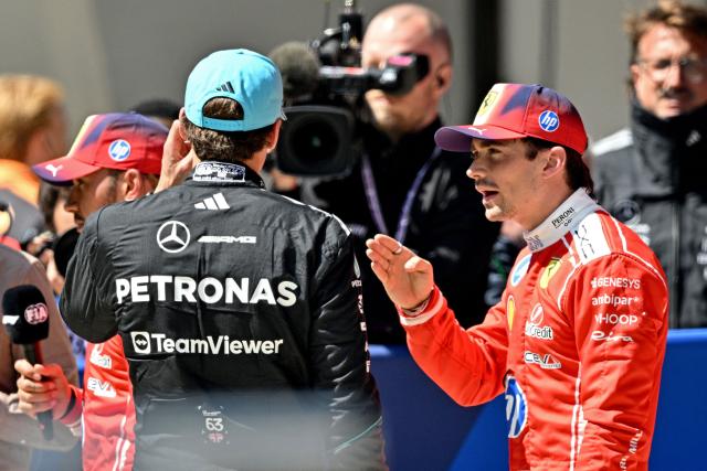 Ferrari's Monegasque driver Charles Leclerc (R) speaks with Mercedes' British driver George Russell at the end of their sprint race ahead of the Formula One Chinese Grand Prix at the Shanghai International Circuit in Shanghai on March 14, 2026. (Photo by HECTOR RETAMAL / AFP)