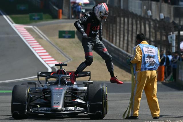 Audi's German driver Nico Hulkenberg gets out of his car after stopping during the sprint race ahead of the Formula One Chinese Grand Prix at the Shanghai International Circuit in Shanghai on March 14, 2026. (Photo by Greg Baker / AFP)